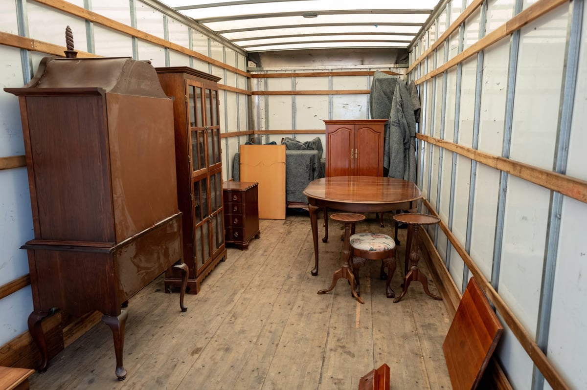 Household items being loaded into a moving truck during an estate cleanout